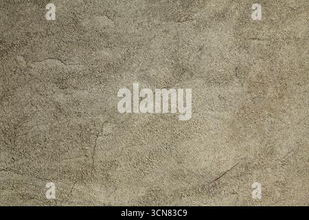 Grey faded wall texture, background. Yellowed cement coating. Gray surface backdrop. Structural and textured plaster with cracks and blackening Stock Photo