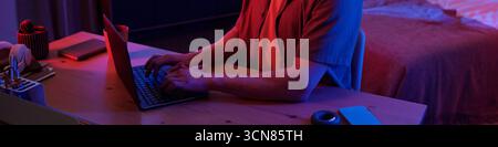Man Using Laptop Computer While Working Late at Night Stock Photo