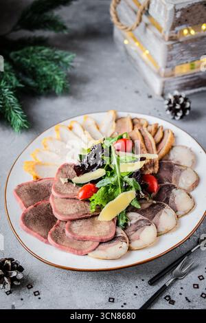 Savory Gourmet Assorted Meats Platter Artfully Arranged with Fresh Greens and Colorful Vegetables Stock Photo