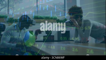 Gesturing man and woman exploring augmented financial data on table in office, with VR headsets Stock Photo