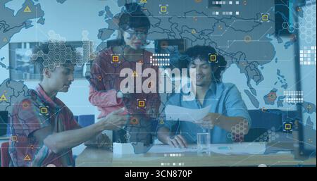 Collaborating tech professionals examining prototype, reviewing docs in office with overlay Stock Photo