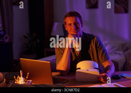 Portrait of Man Using Virtual Reality Headset at Desk Stock Photo