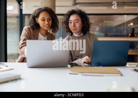 Engaging in a Collaborative Work Session within a Modern Office Environment for success Stock Photo