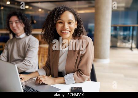 Young Professionals Themed Modern Office Collaborating and Engaging in Creative Tasks Together Stock Photo