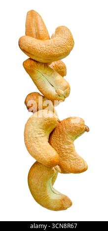 Roasted peeled cashew nuts in stack are isolated on white background with clipping path. Stock Photo