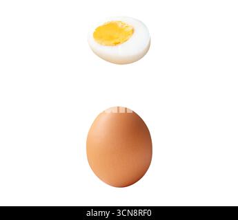 Top view set of raw brown chicken egg and cooked or boiled chicken egg with egg yolk in half is isolated on white background with clipping path. Stock Photo