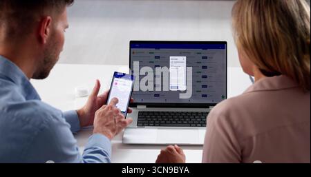Man And Woman Using Laptop Computer And Phone For Job Search.  Person Applying For Employment Opportunities Online Stock Photo
