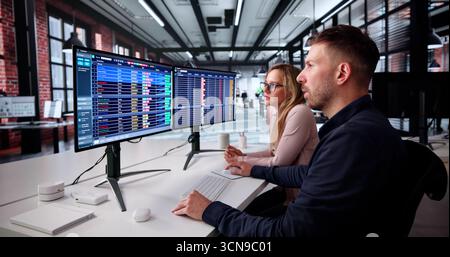 Data Analyst Analyzing Spreadsheets On Computer In Medical Office Setting. Stock Photo
