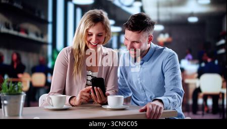 Multicultural Couple Having A Great Time At A Cafe Together. Stock Photo