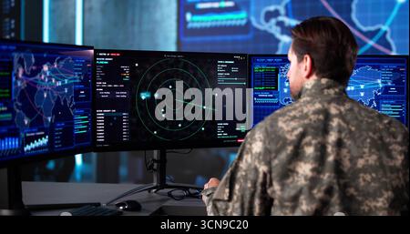 Senior Army Officer Analyzing Aerial Surveillance Data In Command Center Stock Photo