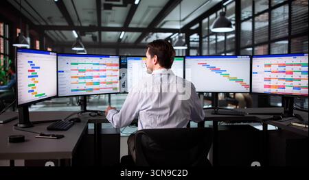 Senior Project Manager Using Scrum Software To Monitor Office Tasks Stock Photo