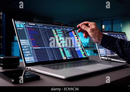 Senior Accountant Working Late On Tax Audit With E-Invoice Spreadsheet Stock Photo