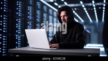 Man In Mask Breaks Into Virtual System, Hacking For Data. Stock Photo