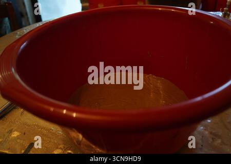 A bowl holds smooth, brown tahini, ready for traditional Greek tahini soup. The image highlights the rich texture of this Mediterranean cooking stable Stock Photo