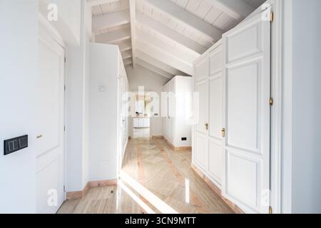 an image of inside a luxury walk in wardrobe leading to private bathroom in mediterranean mansion Stock Photo