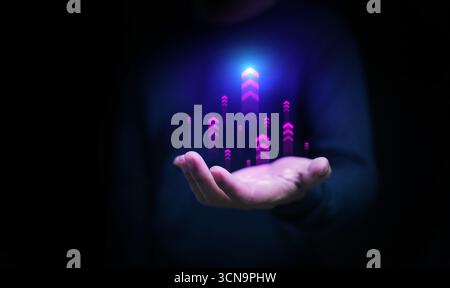 Abstract technology background of neon arrows rising above a hand, representing progress, leadership, career success, investment growth, and digital t Stock Photo