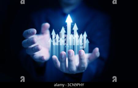 Abstract futuristic concept with hands holding rising arrows, representing opportunity, prosperity, career achievement, corporate success, digital tra Stock Photo