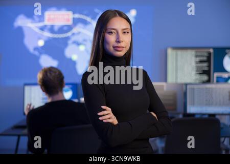 Professional Female Analyst Working in a Security Operations Center with Digital Displays Stock Photo