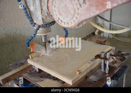 Robot working on milling sculpture in natural stone Stock Photo