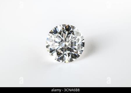 A white diamond is sitting on a white background. The diamond is the main focus of the image, and it is the most important thing in the scene. The whi Stock Photo