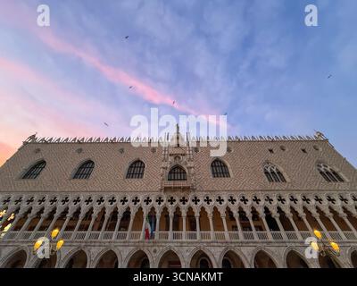 Low-angle view of the southern side of the Doge's Palace, overlooking Riva degli Schiavoni, against sunset sky, Venice, Veneto, Italy Stock Photo