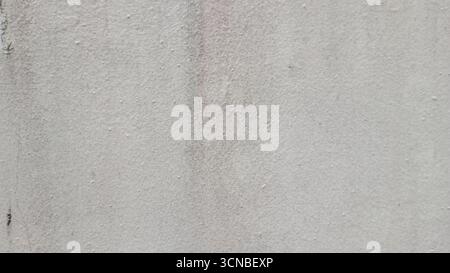 Textured grey concrete wall with weathered imperfections and subtle gradient background Stock Photo