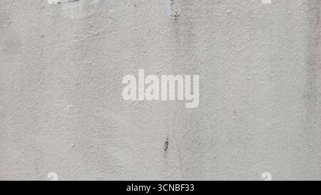 Textured grey concrete wall with weathered imperfections and subtle gradient background Stock Photo