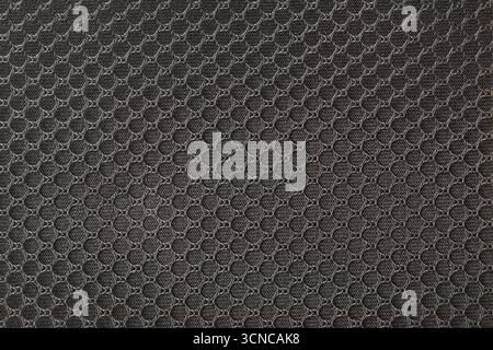 dark fabric mesh texture geometric honeycomb pattern, monochromatic color abstract full-frame background or backdrop for graphic designing Stock Photo