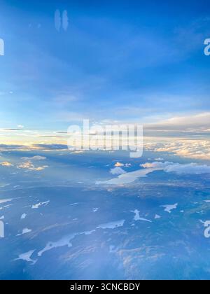 High view from a passenger porthole window of several fjords in Hallingsskarvet National Park as the Autumn sun sets over the north-west of Oslo, capi Stock Photo