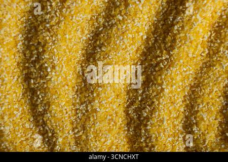 Abstract Yellow Cooking Corn Grits Background. Stock Photo