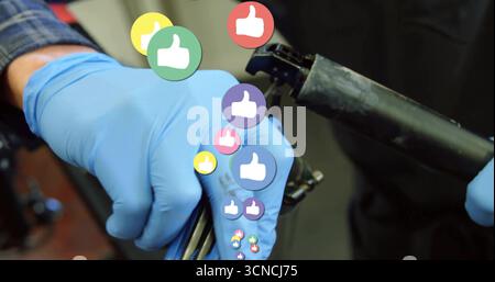 Adjusting seat post clamp with mechanic's nitrile-gloved hands in workshop, with thumbs-up graphics Stock Photo