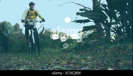 Cyclist riding mountain bike on trail with yellow jacket helmet backpack chat bubbles, copy space Stock Photo