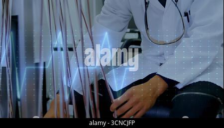 Technician wearing lab coat handling colored wires in examination room, with ECG waveform overlay Stock Photo
