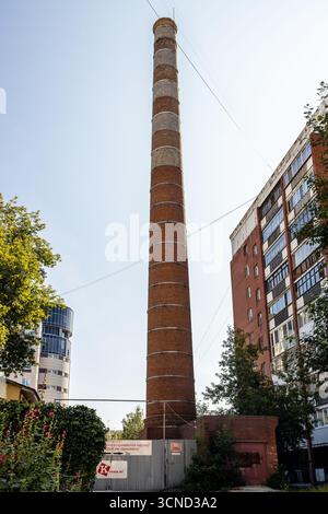 Yekaterinburg, Russia - August 2, 2025: pipe of heating boiler in Yekaterinburg city yard on sunny summer day Stock Photo