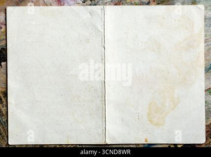 blank spread of old shabby paper on vintage table close up Stock Photo