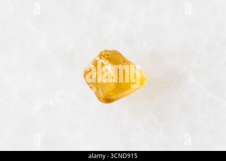 sample of rough jargoon zircon crystal on white marble background close up from Cambodia Stock Photo