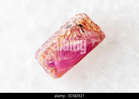 sample of raw pink ruby crystal on white marble background close up from Myanmar Stock Photo