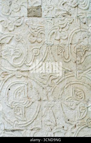 A white old wall with barillefs of stucco. Stone Texture Background with Patterns and Barillefs. High quality photo Stock Photo