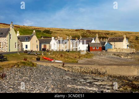 The historic fishing harbour of Sandend on the Aberdeenshire coast, nestled within the traditional village. Stock Photo