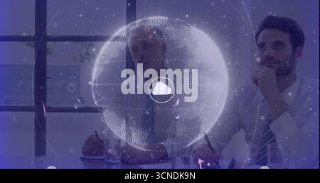 Two colleagues studying floating holographic globe with cloud icon in conference room, holding pens Stock Photo