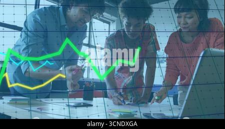 Collaborating three coworkers analyzing financial charts at office desk with laptop, sticky notes Stock Photo
