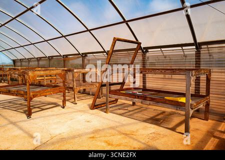 Unused drying racks stand empty in Hawaii, a reminder of traditional methods once used to sun-dry harvested beans. Stock Photo