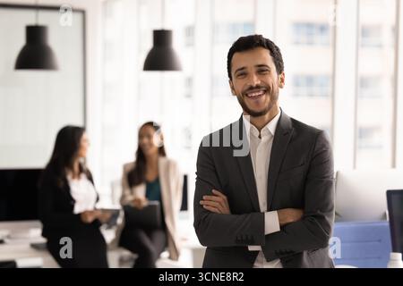 Happy young business leader man posing in office Stock Photo