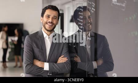 Happy product manager man standing close to training glass board Stock Photo