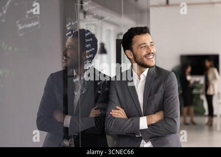 Happy young business project manager man standing at glass board Stock Photo