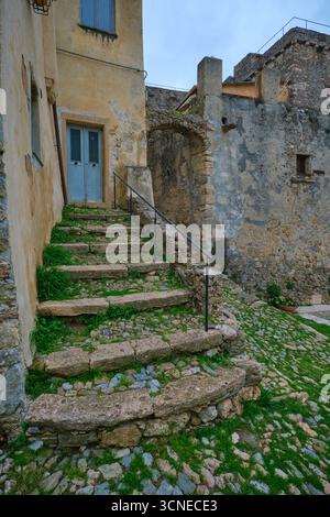 Old, worn, moss covered exterior stone, rock stairs, steps. Rich patina. In the rural village of Borgio Verezzi. In Liguria, Italy. Stock Photo