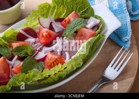 Sliced Baby Beetroot in an onion and tomatoe salad Stock Photo
