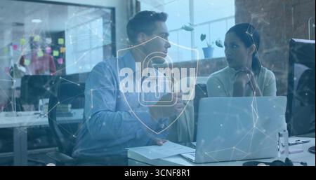 Collaborating colleagues gesturing and listening in open-plan office, with shield lock overlay Stock Photo
