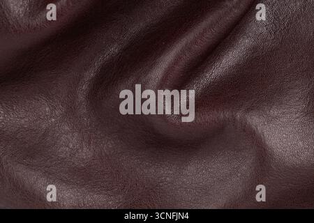 Close up of wrinkled brown leather surface showing natural grain and texture folds Stock Photo