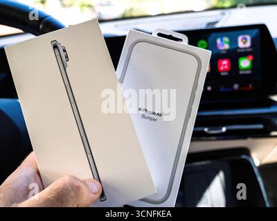 Paris, France - Sep 19, 2025: Close up of hand holding new Apple iPhone Air retail box alongside Apple iPhone Air bumper packaging inside modern elect Stock Photo